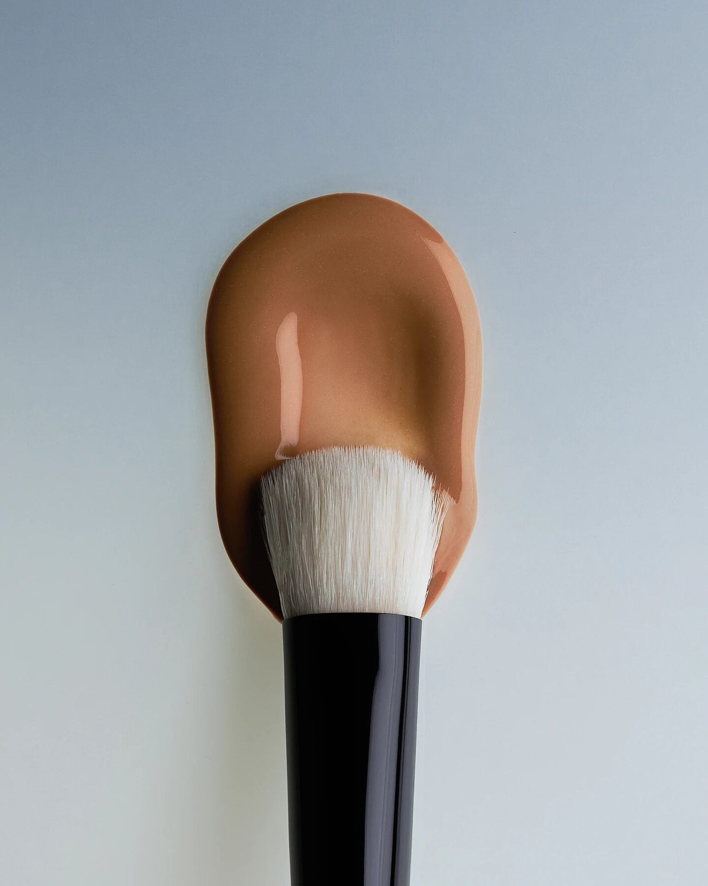 Texture du Milk Teinté FIRN déposée sur un pinceau de maquillage