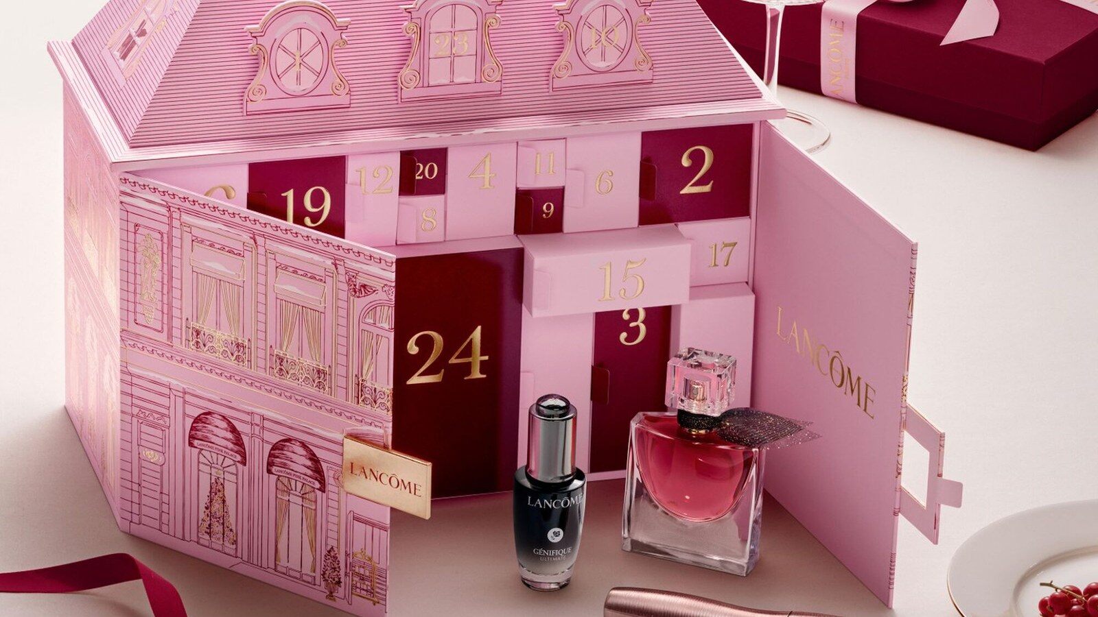 Le calendrier de l’Avent Lancôme 2026 en forme de palais rose, ouvert sur ses cases numérotées, avec le sérum Génifique et le parfum La Vie est Belle