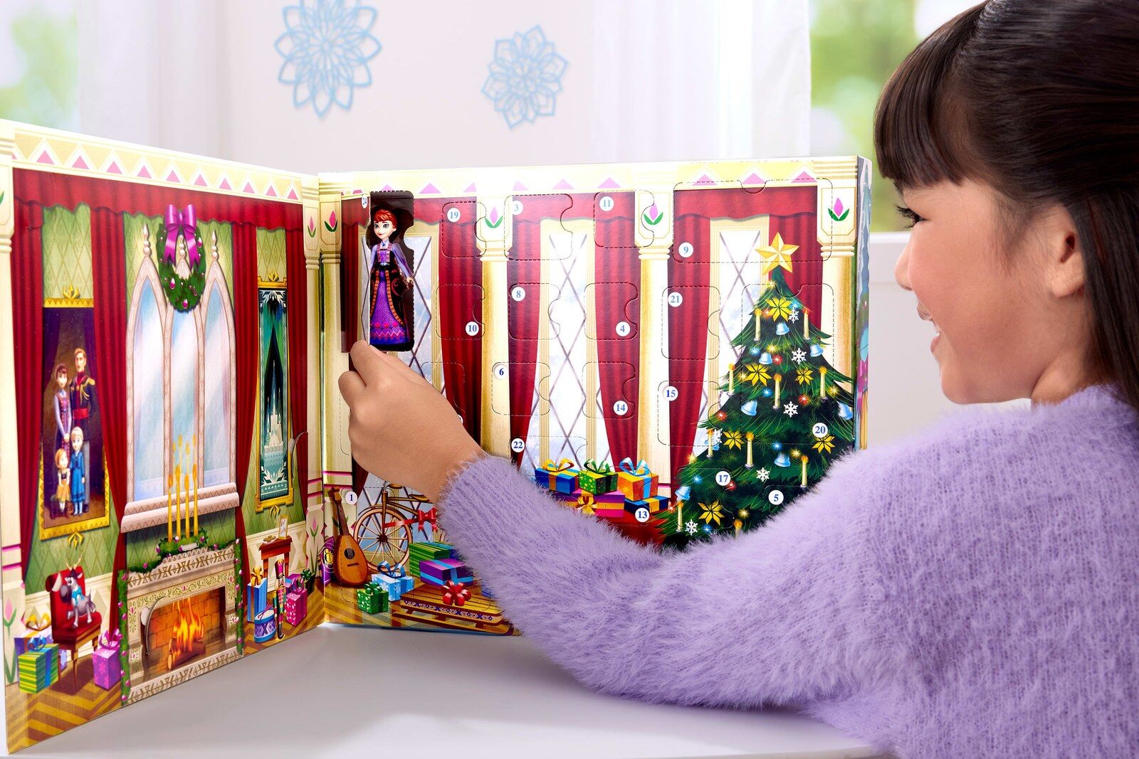 Une enfant ouvre une case du calendrier de l’Avent La Reine des Neiges 2026 et découvre la poupée de la reine Iduna
